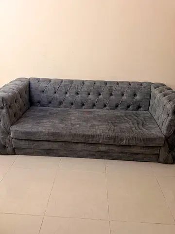 Grey tufted 3-seater sofa cum bed in good condition