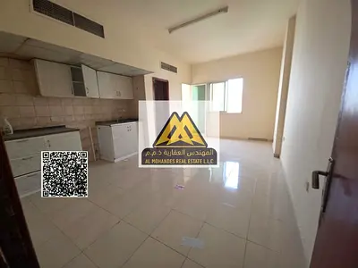 Studio in Al Rawda 1, Ajman near Kenz Mall. Spacious with balcony and great view, central AC. Rent AED 19,000 yearly, 6 payments, prime location.