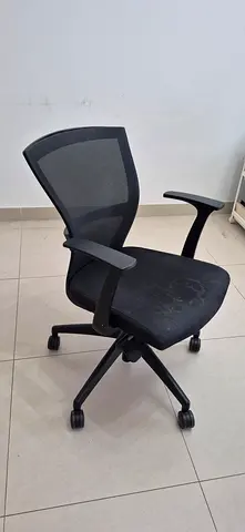 Used ergonomic mesh office chair with armrests and wheels