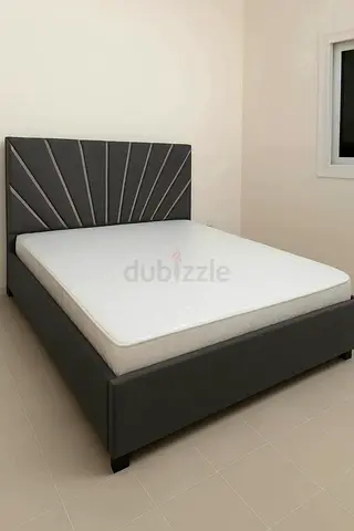 Grey upholstered double bed with mattress - modern headboard