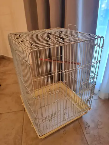 Medium white metal bird cage with perch and ( removable tray at the bottom is missing)