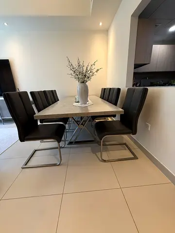 Modern marble-top dining table with 8 leather cantilever chairs with console