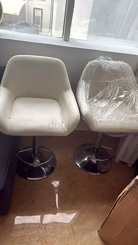 Pair of white swivel bar stools with chrome base — good condition