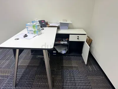White L-shaped Office Desk with Lockable Pedestal - Good Condition location Dubai oasis
