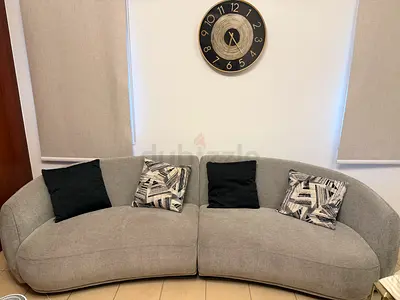 Light grey curved 2-piece fabric sofa — excellent condition