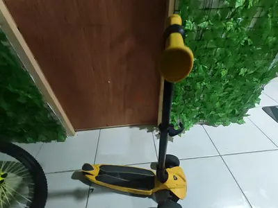 Yellow kids three-wheel kick scooter — good condition