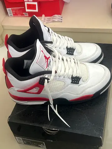 Pair of white, black and red Jordan 4 sneakers (used) - size 8.5 us bought in dubai mall