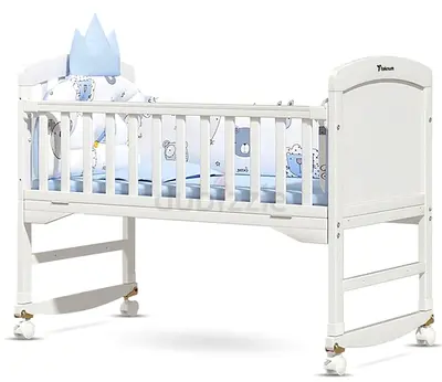White Wooden Baby Crib/Bassinet with wheels and rocking mode. Sparingly used