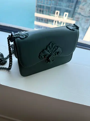 Charles  Keith Small crossbody womens handbag with decorative clasp and chain strap
