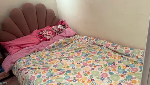 Used double bed with scallop headboard and floral bedding