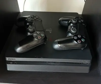 PlayStation 4 Slim with 2 DualShock 4 Controllers - Good Working Condition