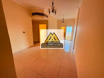 For Annual Rent – Ajman, Al Nuaimiya 2Two-bedroom apartment with living room, 2 bathrooms, and a balcony with open views