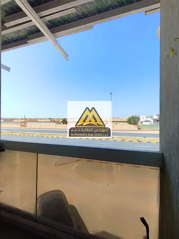 Apartment for rent in Al Alia, Ajman, with a balcony, central AC, located on the main road, close to Dubai and Sharjah exits, comfortable space, suita