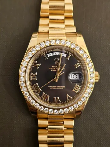 Gold Rolex Day-Date style watch with diamond bezel