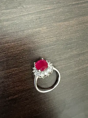 Silver ring with natural ruby center stone and halo setting
