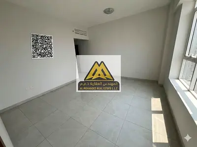 For annual rent: A two-bedroom apartment with a living room in a prime location, second row from Ajman Corniche. It boasts a beautiful sea view and is