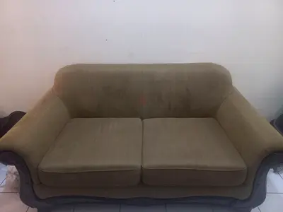 Two-seater upholstered sofa with wooden trim - used