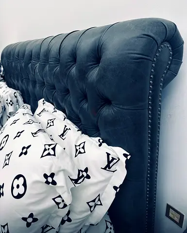 Luxurious Black studded leather bed from “The One” with matching silver studded side tables