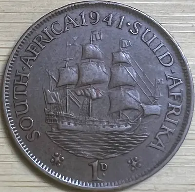 1941 South Africa 1 Penny coin featuring:
	•	Obverse (front):
George VI
The inscription “GEORGIVS VI