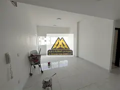 Spacious one-bedroom apartment with a living room, balcony, and built-in wardrobes for annual rent 