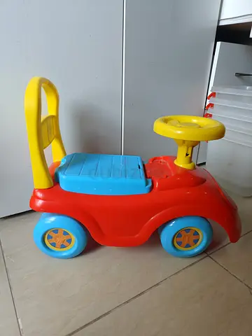 Red and blue plastic ride-on toddler car — good condition