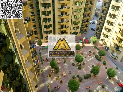 Two-bedroom apartment with a living room and balcony, in a prime location close to Dubai and Sharjah exit