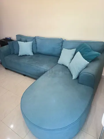 L-shaped teal fabric sofa with chaise, good condition