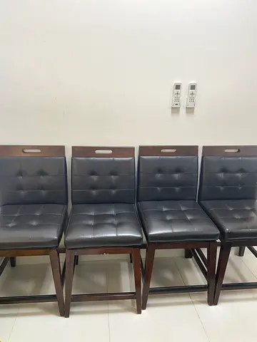 Set of 4 wooden dining chairs with grey tufted cushions