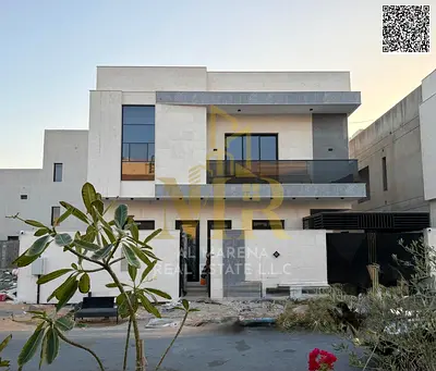 Two-story villa with a rooftop terrace, including electricity, water, and air conditioning, in one of Ajman's most prestigious areas. Freehold ownersh