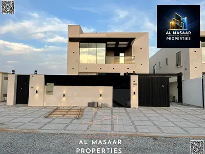 Luxury villa in Al Muwaihat 2, modern design with a yard, outdoor seating area, and central air conditioning.