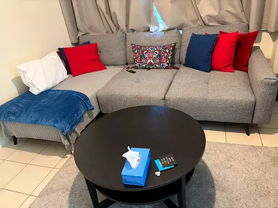 Light Grey L-Shaped Sofa with Ottoman and Cushions and table - Good Condition