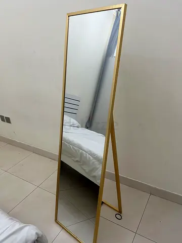 Full-length freestanding gold floor mirror