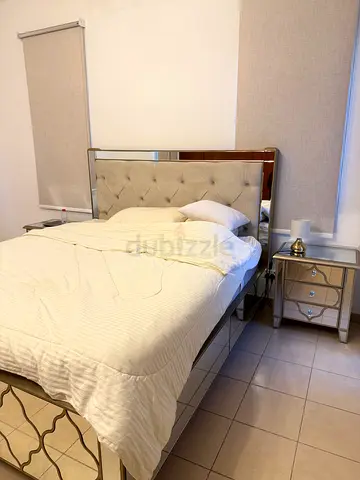 Queen tufted headboard bed with mirrored bedside tables and dressing table