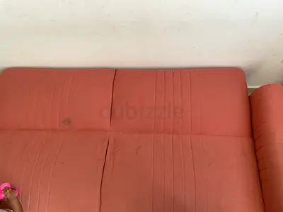 Used four-seater fabric sofa - light rust color, some stains