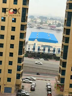 1BR for sale in Ajman Al Khour Towers partial view 1200 sqft 9th floor furnished or unfurnished grea