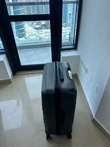 Large black hard-shell rolling suitcase - good condition