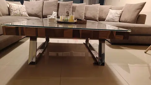 Modern glass-top coffee table with chrome legs. 1.2X1.2m