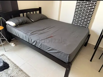 Solid black wooden double bed frame with mattress (good condition)