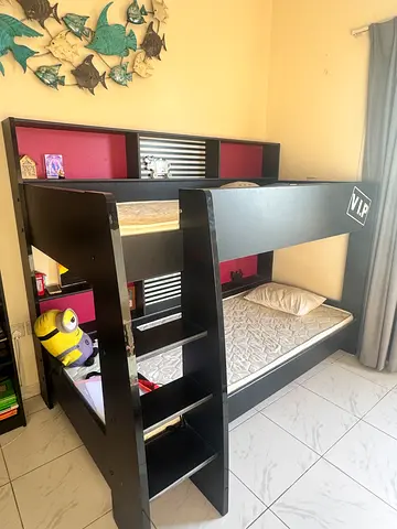 Black wooden loft bed with built-in shelves and desk