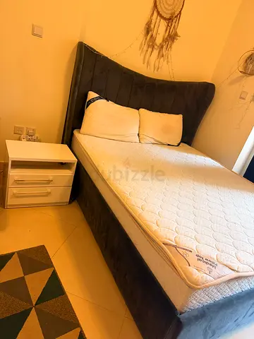 Bed with mattress and side table