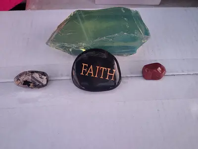 Small polished stones collection with FAITH stone and green glass-like crystal