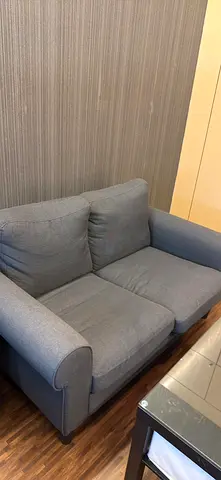 Compact 2-seater Grey Fabric Sofa (Good Condition) with table.
