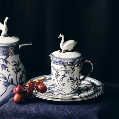 Elegant Swan-Handled Porcelain Tea Cup with Saucer and Lid - Blue Floral Design