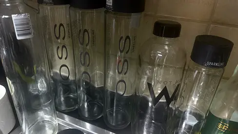 Set of empty VOSS glass water bottles (collection)