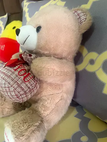 Light beige plush teddy bear with heart cushion - gently used