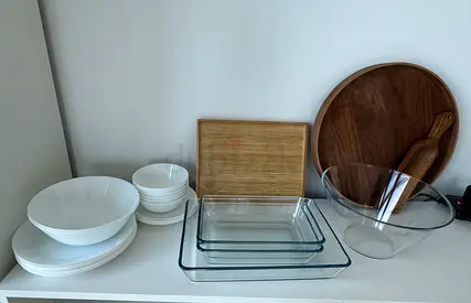 Mixed kitchenware set — bowls, serving plates, glass baking dishes and wooden boards