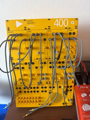 400 modular Pocket Operator style modular synth panel (yellow) with patch cables