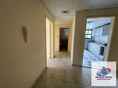 For rent in a house, a two-bedroom apartment with a living room in the Al Qasimia area of ​​Sharjah, with an open view, spacious layout, central air c