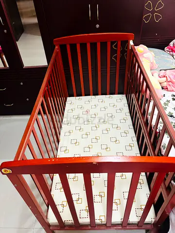 Wooden baby crib with mattress