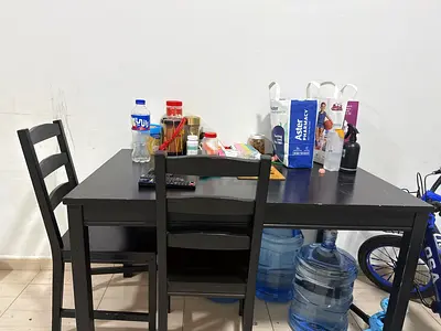 Used black wooden dining table with 2 chairs - compact set